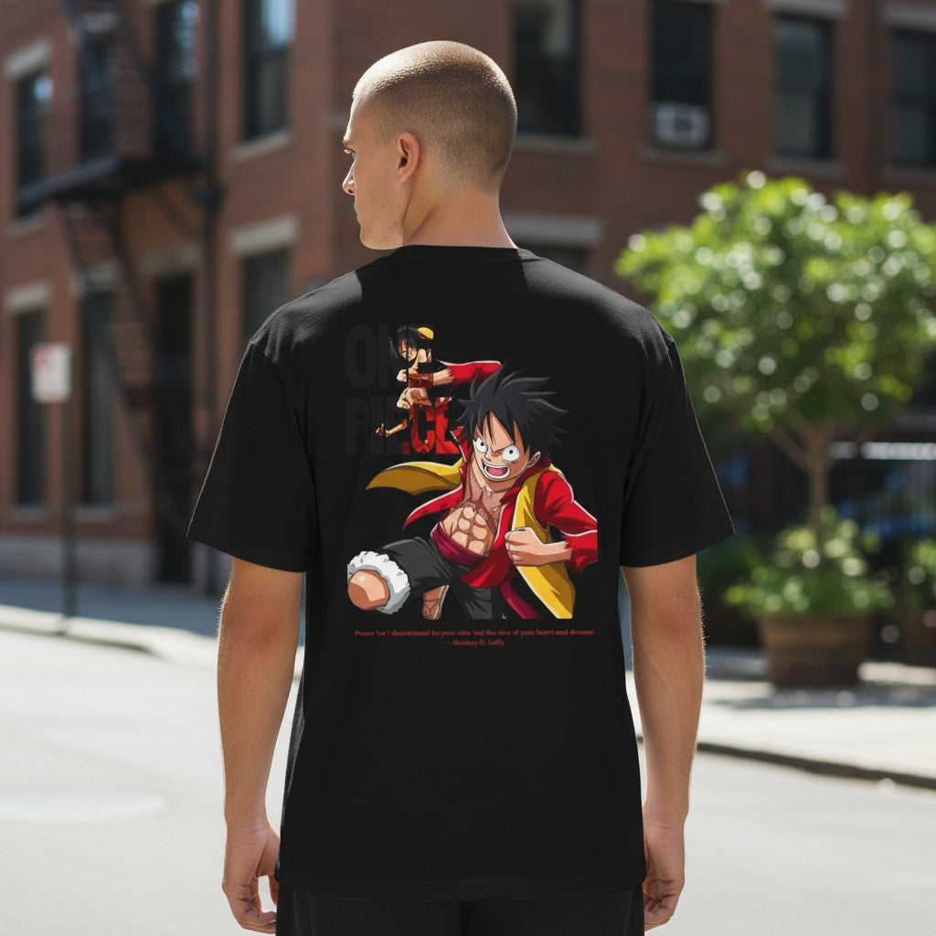 CanvasPrismatique black cotton t-shirt featuring a bold Monkey D. Luffy graphic print on the back, worn by a man.