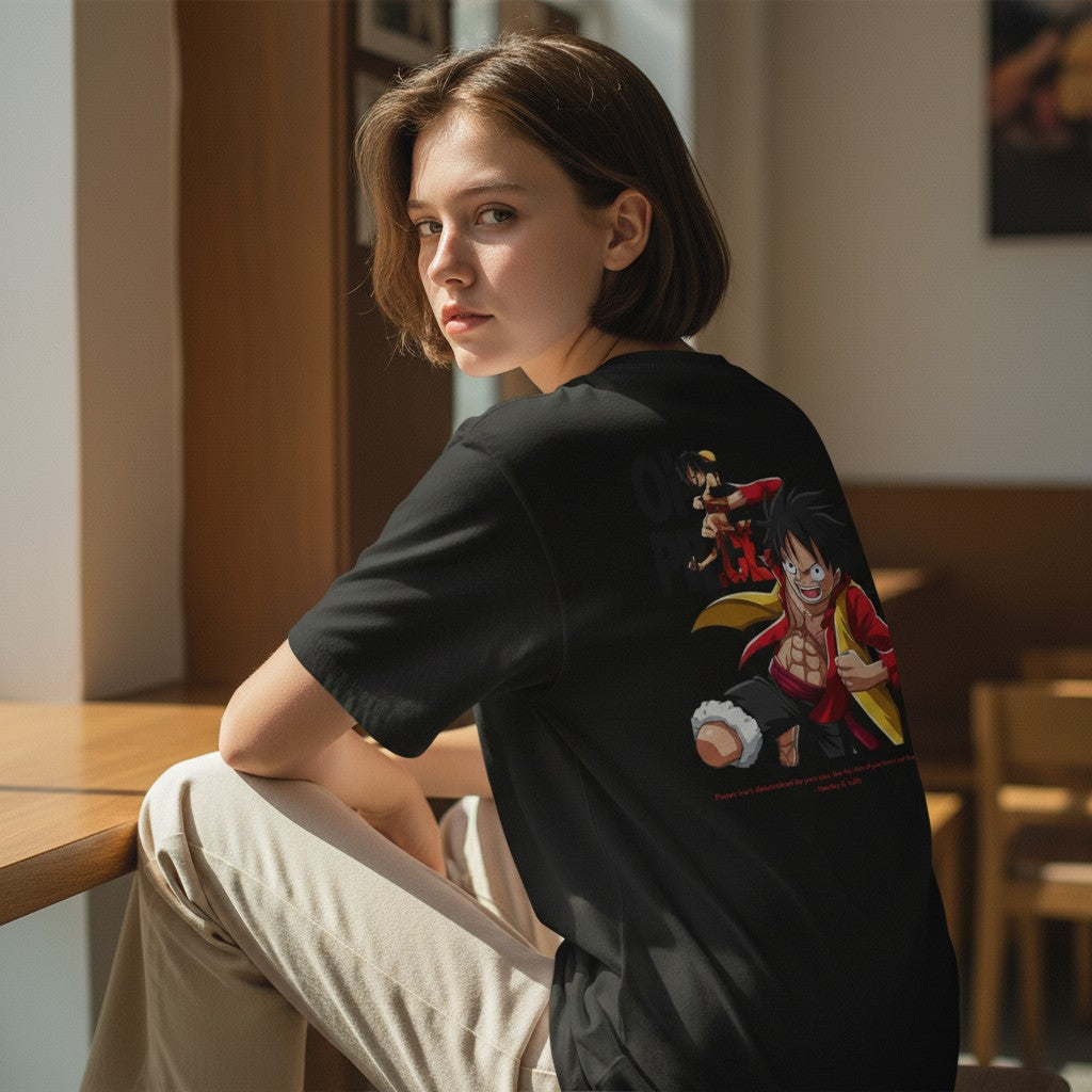 CanvasPrismatique black cotton graphic tee featuring a vibrant One Piece Luffy illustration on the back